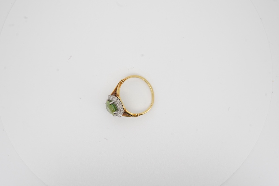 An 18ct, peridot and diamond set oval cluster ring, size K/L, gross weight 4.1 grams. Condition - poor to fair